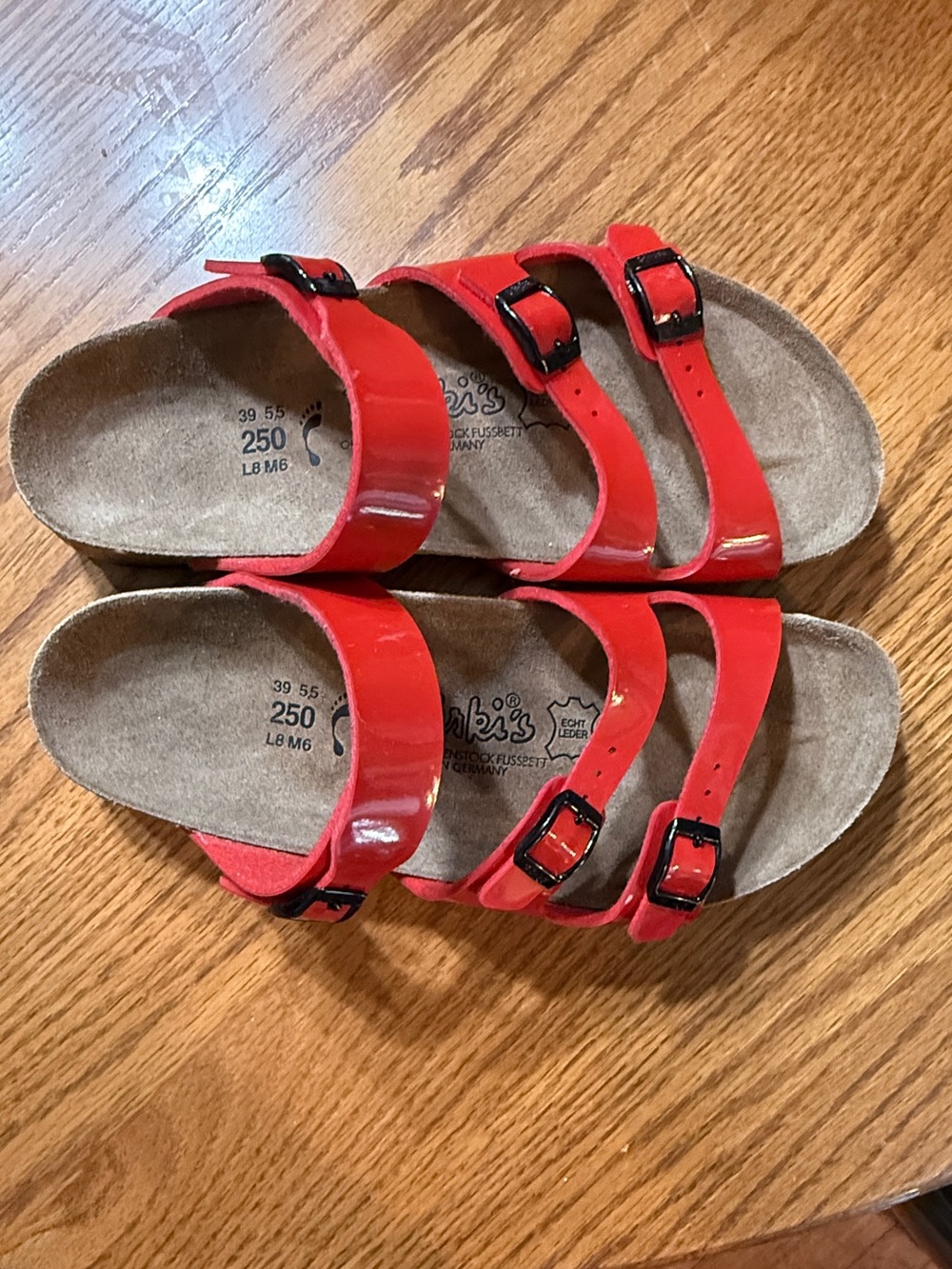 New. Birki’s by Birkenstock Red Triple-Strap Sandals with Black Buckles